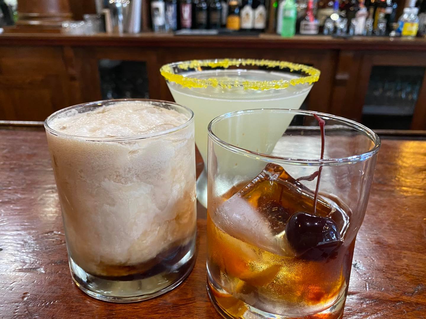 three different cocktails on the bar