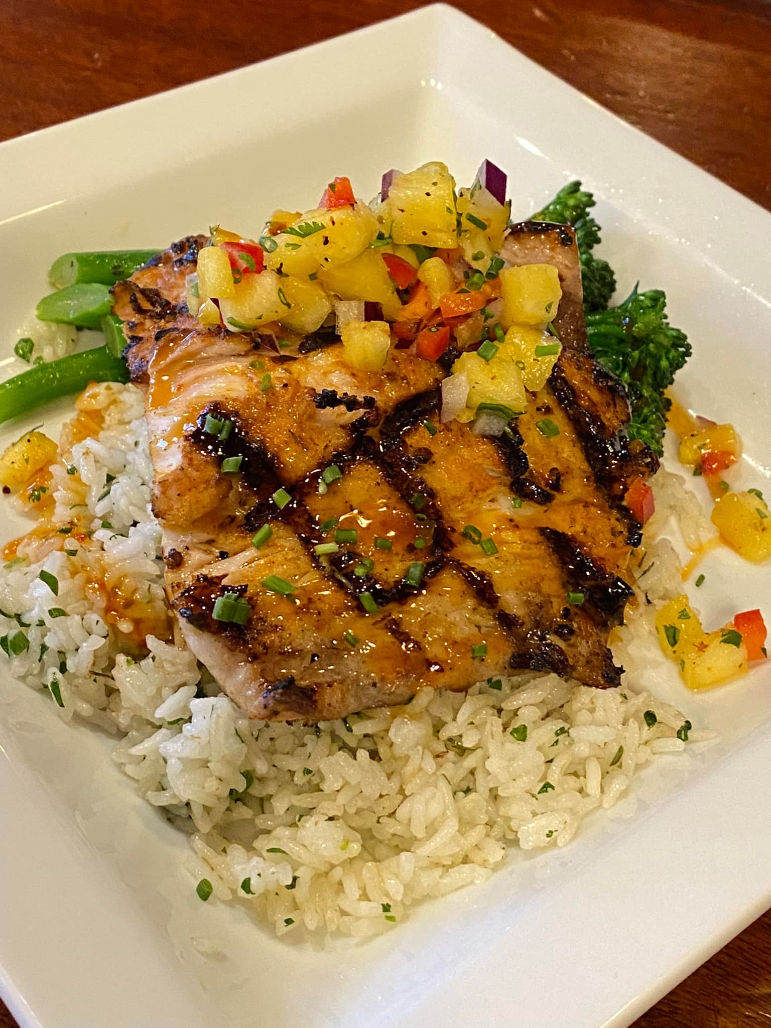 chicken served over rice and vegetables